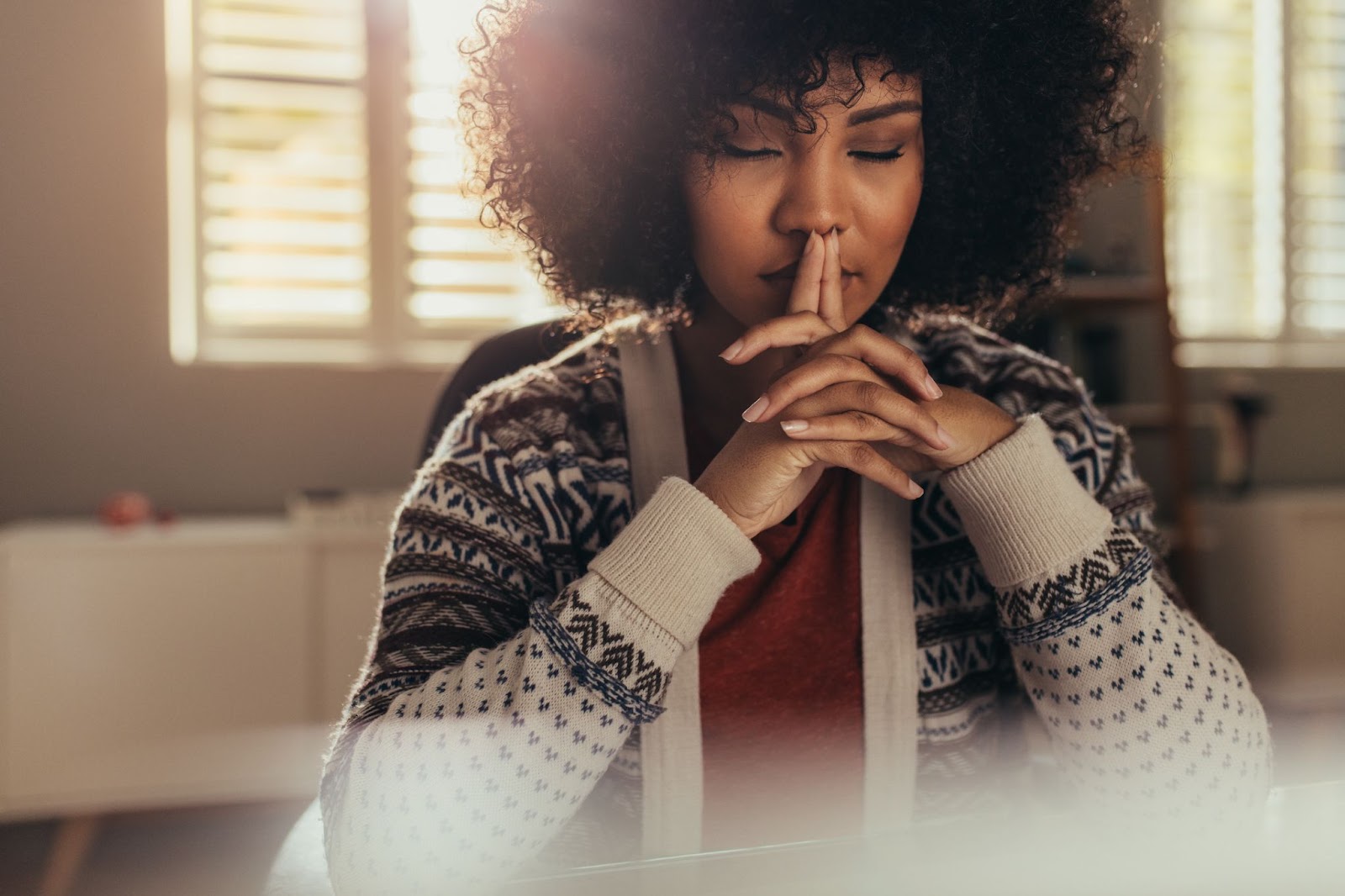 Young healthy woman meditating at her desk